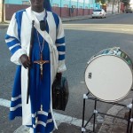 ANTHEA McGIBBON PHOTO: All set for Christmas blessings in Sir William Grant Park, this priest makes his way to free people of problems.